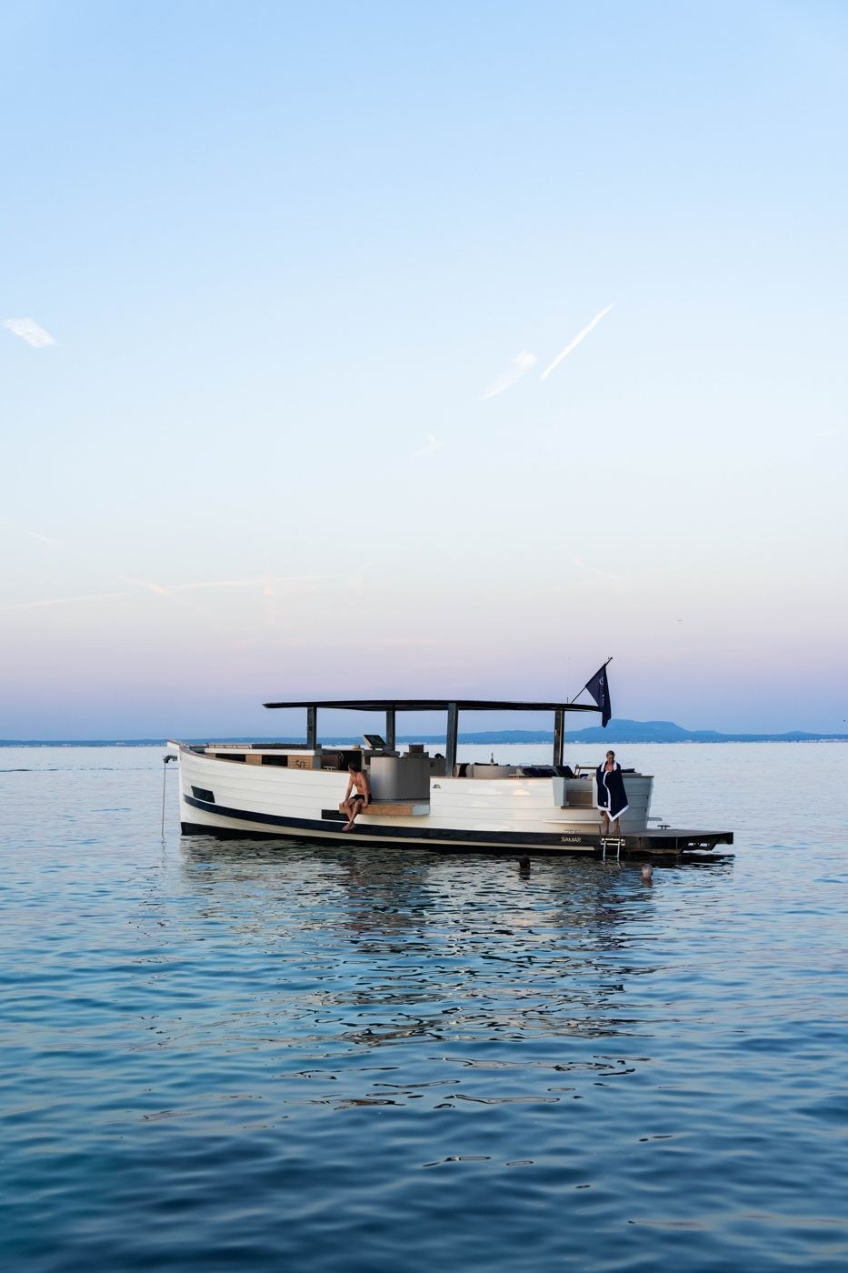 The SAMAR 50 “SAONA” at anchor at dusk, with guests swimming