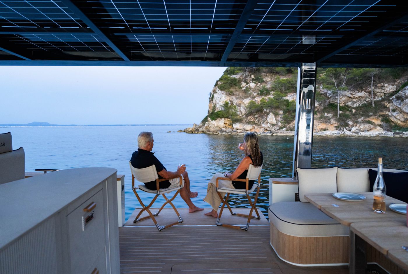 Guests on the aft deck of the SAMAR 50 in a cove
