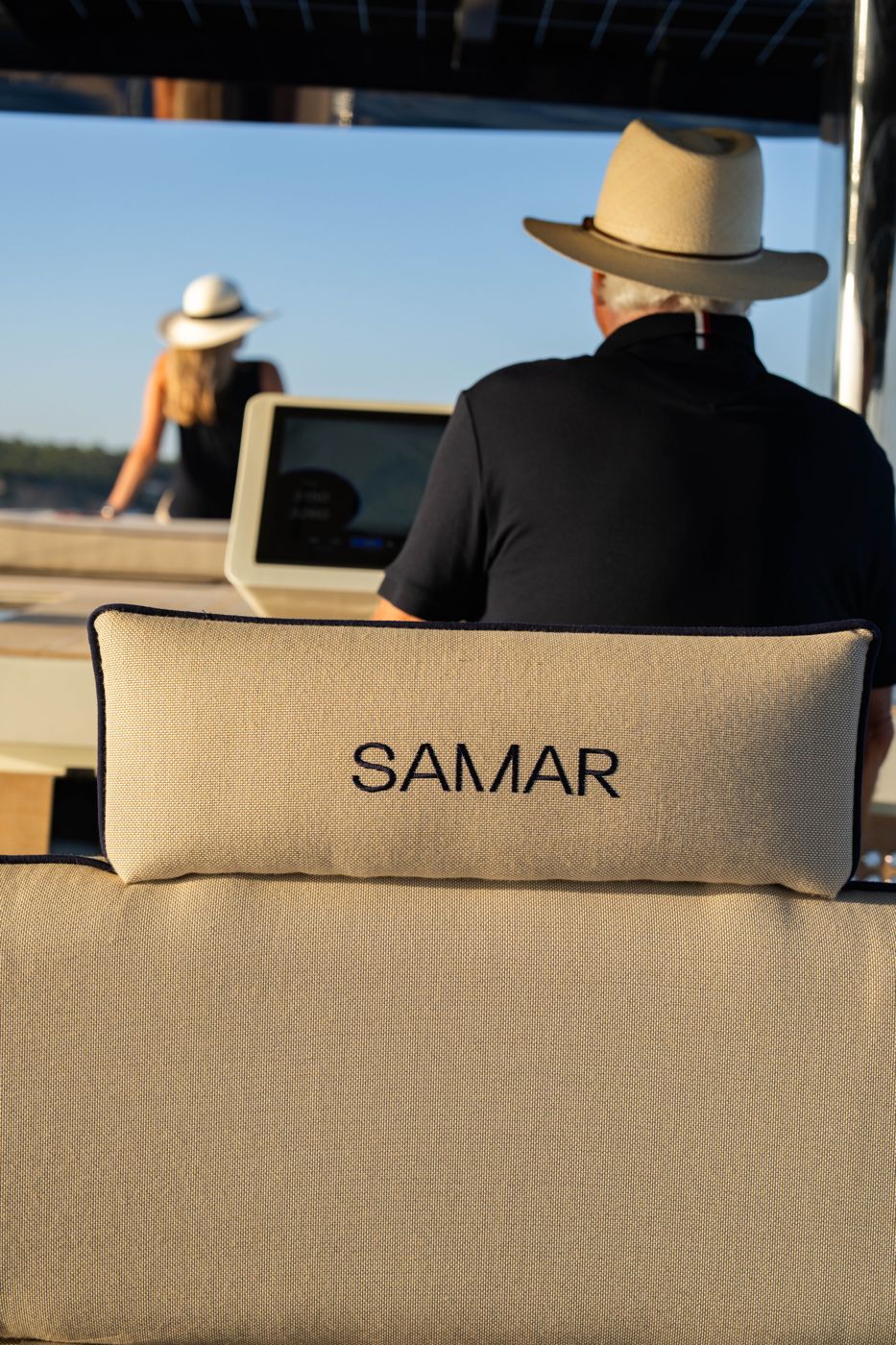 Owner at the helm behind a SAMAR-embroidered cushion